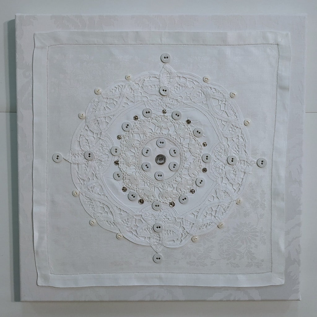 Laundry Mantra: Button Button by Lesley Turner  Image: Lesley Turner, 'Laundry Mantra: Button Button', 2021, 18" x 18" x 1". Vintage cotton domestic linens, buttons, metal snaps, polyester thread. The task of doing laundry is no sooner done than it needs to be repeated. 