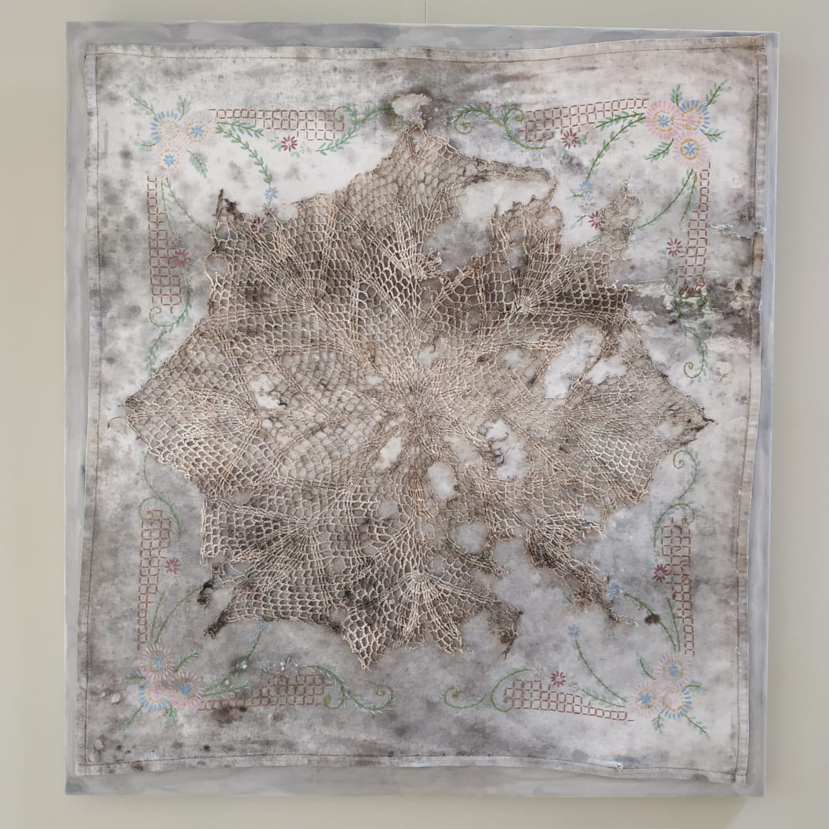 Stain, Launder, Repeat by Lesley Turner  Image: Lesley Turner, 'Stain, Launder, Repeat', 2019, 37"x34"x0.5", Tree stained afternoon tea cloth, composted doily, polyester, and cotton thread. The epitome of the relentless laundry cycle, these handmade cloths are repeatedly stained and laundered until worn out.