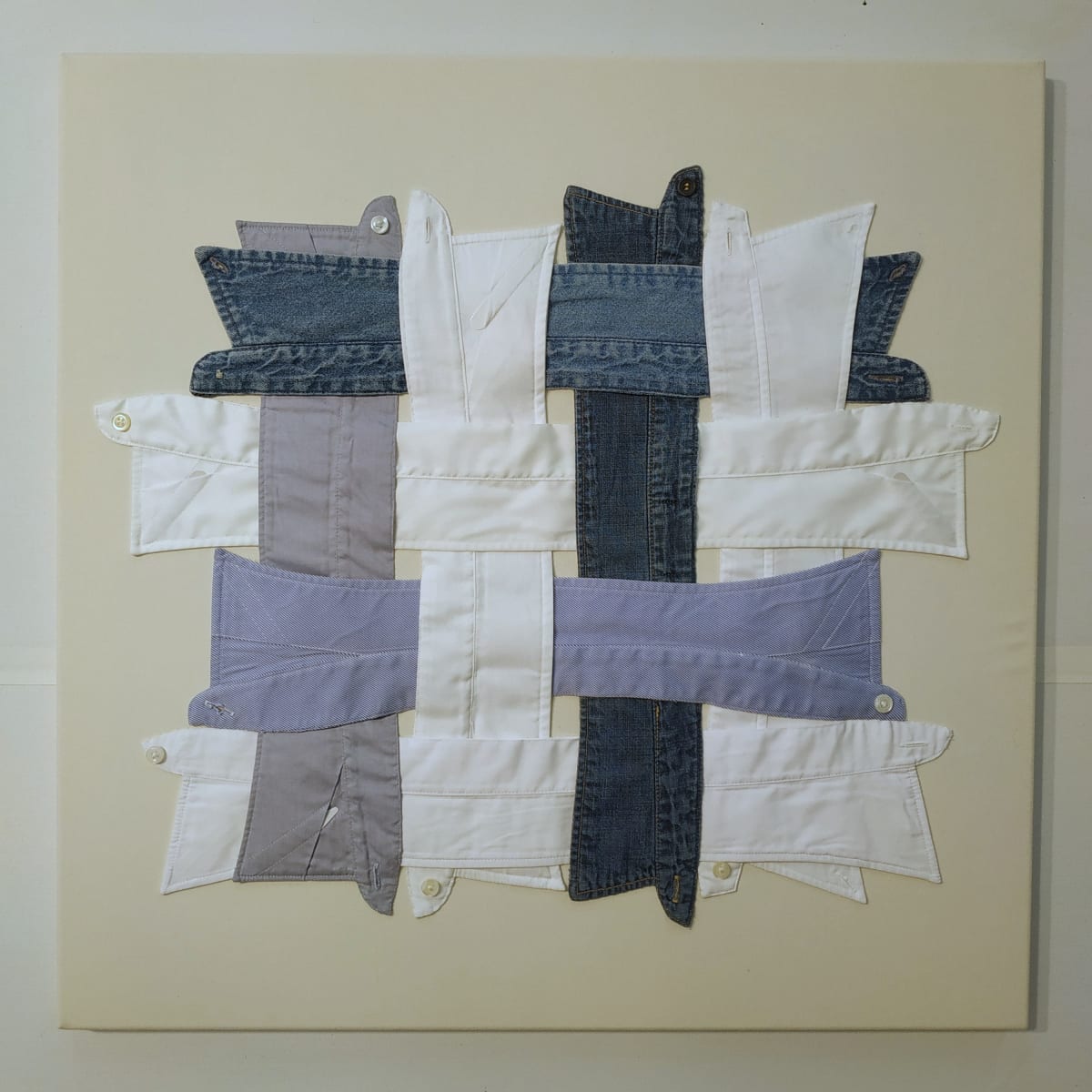 Interdependence by Lesley Turner  Image: Lesley Turner, 'Interdependence', 2020, 24"h x 24"w x 0.5"d. Men's cotton shirt collars, worn bedsheet, polyester thread.  A society woven from the threads of cooperation, shared responsibilities, and collaborative efforts, 