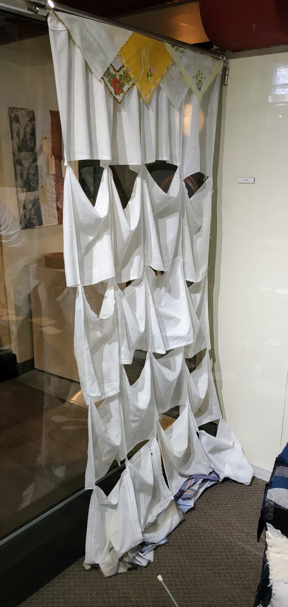 Homesickness by Lesley Turner  Image: Lesley Turner, 'Homesickness', 2018, 75"h x 50"w x 5"d. Cotton handkerchiefs are stitched together to form a curtain. Handkerchiefs were used when one was physically ill as well as when one was emotionally traumatized by grief. They persist as a signal of public mourning. 