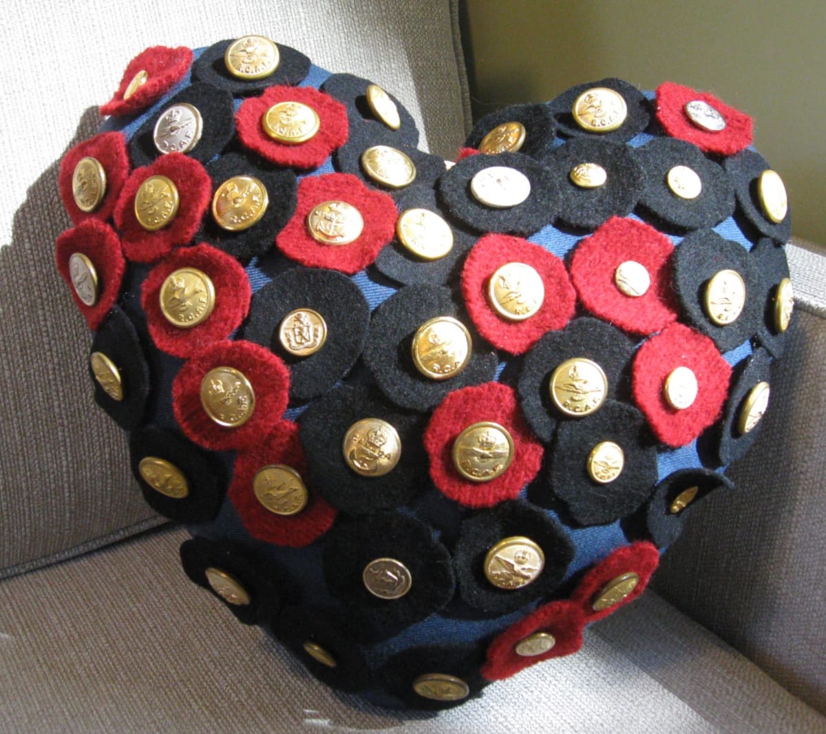 Soldier's Heart by Lesley Turner  Image: Lesley Turner, 'Soldier's Heart',  2018, 14"h x 14"w x 3"d. An air force uniform textile heart-shaped pillow embellished with military buttons and wool felt flowers.