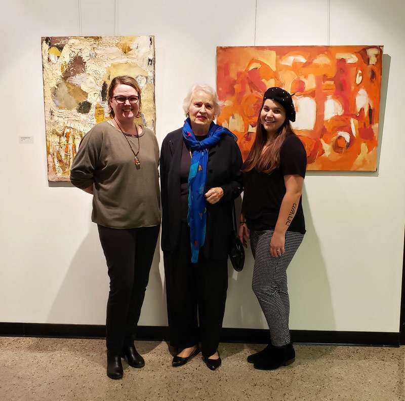 Professor Allison McElroy Benefield (left), Miriam McClung (center), and Morgan Worsham, gallery coordinator at the show.