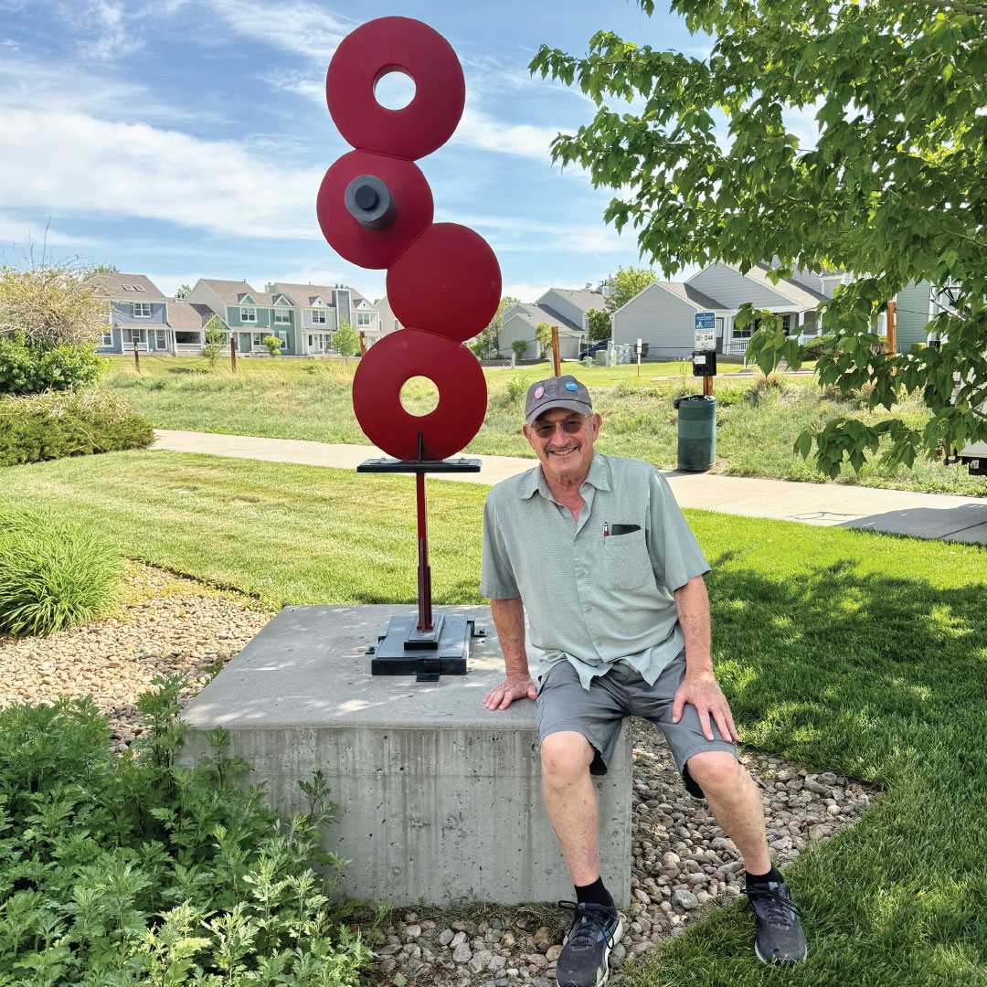 Disco Deco by Andy Libertone  Image: Andy shares that most of his inspiration comes from the urban environment, as he’s always lived near or in urban areas. “Whether it be my metal sculpture or other media, I have always tried to push my images forward.” Visitors will see that “Disco Deco” embraces that urban aesthetic. It’s a bright and colorful sculpture that incorporates four farm disks borrowed from another piece he created in 1973. Taking inspiration from deco design, Andy says the final sculpture suggests a small deco table.