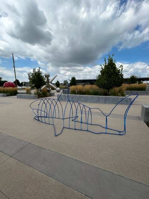 The Maneater (Permanent Public Art) by Jim Choate  Image: Following suit with the trend of combining utility with beauty, “ManEater” by Jim Choate, is a welded steel shark that doubles as a bike rack. ManEater was intended to give the viewer an up close and personal idea of the average size of a young adult Great White Shark. Please feel free to park and lock up your bike in the belly of this ocean predator before exploring Discovery Park.