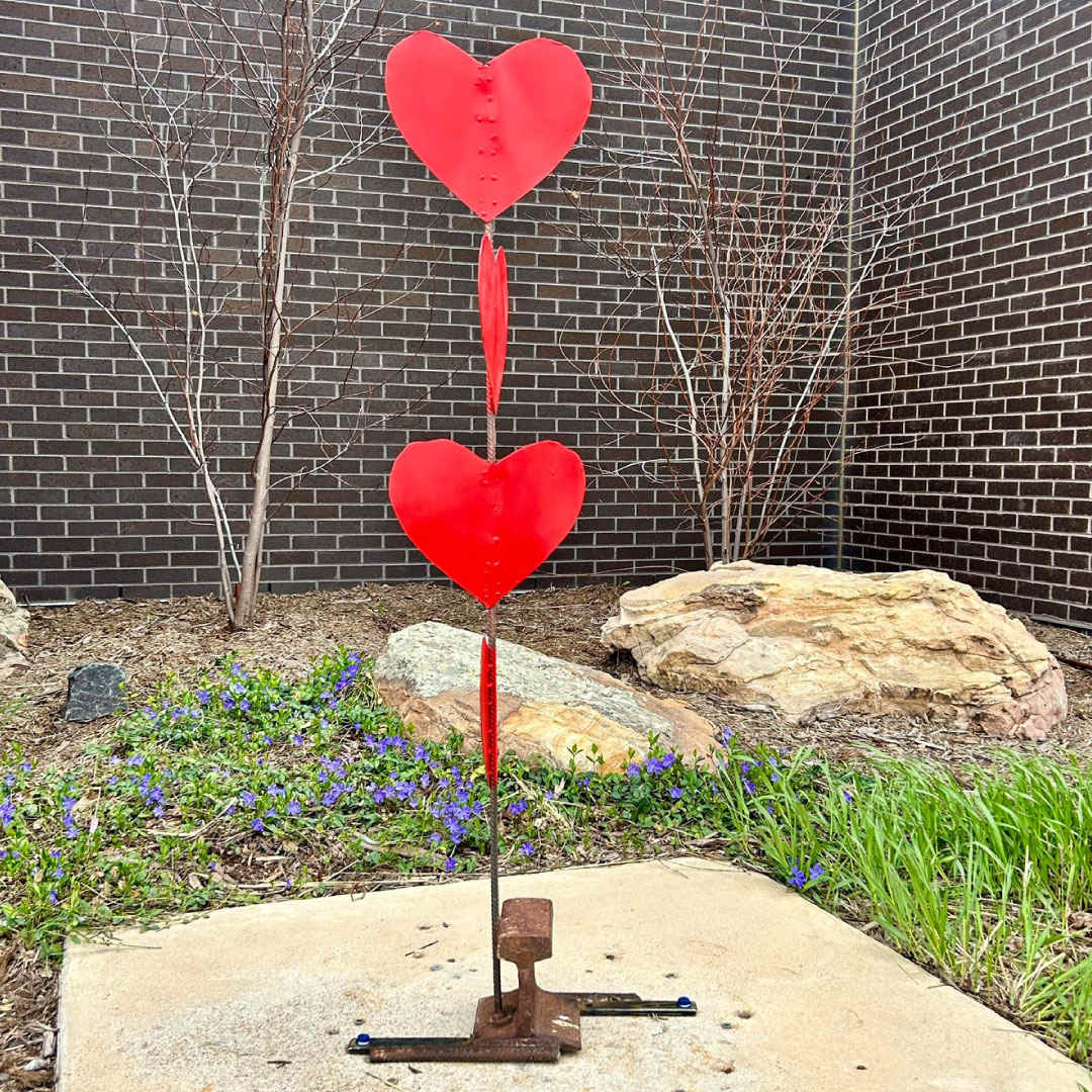 Love Wins (Art Encounters 2024) by Janene DiRico-Cable  Image: Janene DiRico-Cable shares that her sculpture “Love Wins,” which sits outside the PACE Center, is a happy result of very negative treatment during the COVID days when she and her husband decided to counter every negative action with something artistically positive. In fact, during that time, they produced sculptures and pallet wood furniture to donate to those less fortunate in Chaffee County. Love wins!