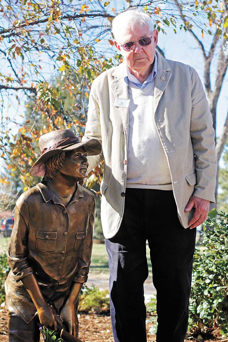 Nancy Gripman (Permanent Public Art) by Don Budy  Image: Parker Task Force founder, active community member, volunteer and avid gardener Nancy Gripman is memorialized in this beautiful bronze sculpture by artist Don Budy. The sculpture is aptly located in a flower bed just south of the gazebo in O’Brien Park.

Seen above: Bill Gripman stands with the statue of his late wife Nancy at the dedication ceremony in O’Brien Park. Gripman led everyone in attendance in a cheer of “hello, Nancy” to welcome the statue.