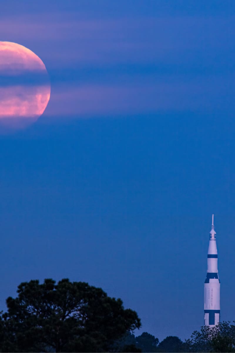 Saturn V (Huntsville, Alabama) by Earl Todd  Image: This is a single shot and does not use Photoshop to enhance the moon. This was shot from just over 4 miles away. The initial plan was to have the moon set directly behind the rocket, but clouds on the horizon on this morning caused a change in plans.