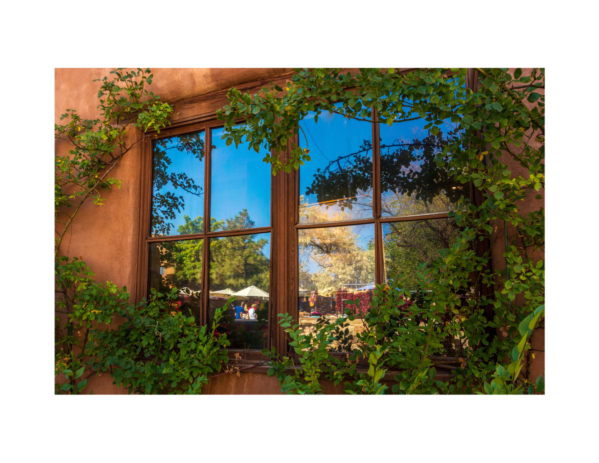 Sante Fe Reflections (Sante Fe, New Mexico) by Margaret Todd  Image: It was gloriously sunny day with perfect blue skies.  Not typically the time to be walking around looking for images.  Photographers much prefer morning and evening light.  But it was the perfect day for reflections.  That perfect blue sky reflected in the windows of the adobe buildings of Old Santa Fe.