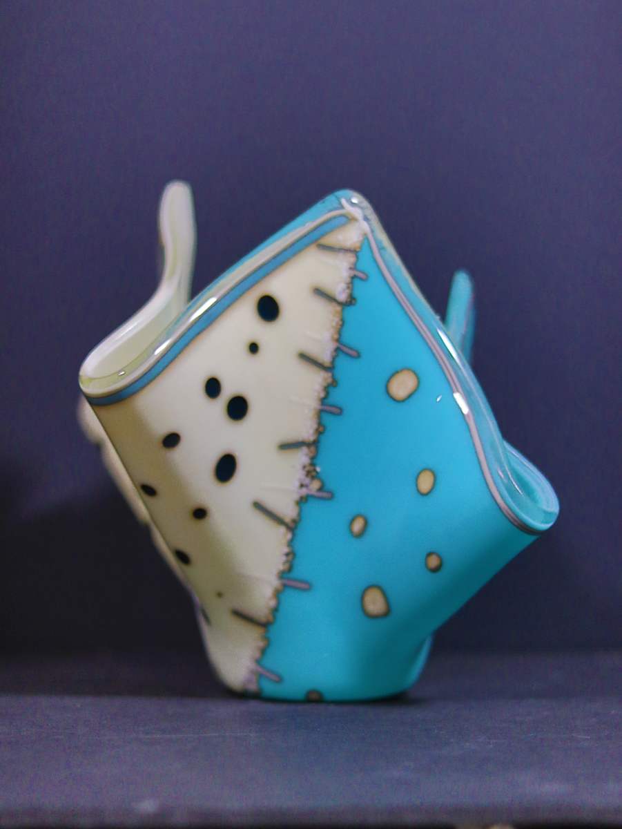 Stitches by Jay Laxton  Image: French Vanilla and turquoise glass with stringer as "stitches" down the middle 