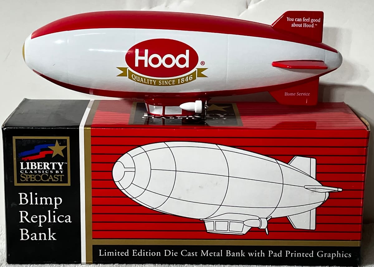 Hood Blimp Replica Bank  Image: Liberty Classics Replica Bank of Hood Blimp made by SpecCast.  Limited Edition Die Cast Metal Bank (Model No. 36016). "Quality Since 1846" pad printed on ribbon below brand name. "You Can Feel Good About Hood" and "Home Service" pad printed graphics on rudder.