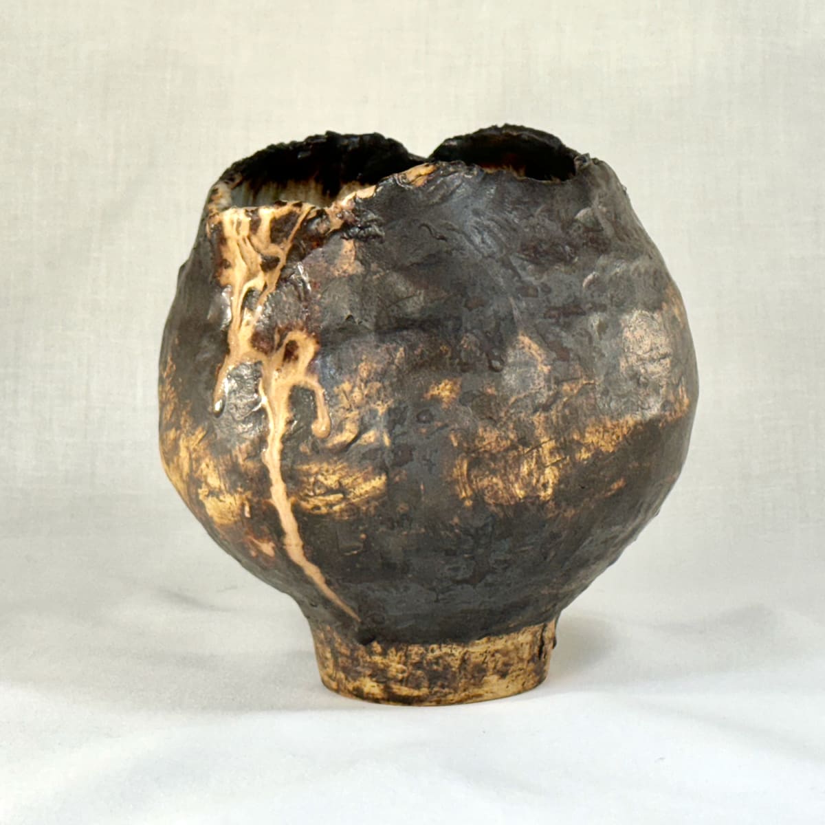 Artifact #1 by Jennifer K Brown  Image: Small but mighty artifact, overflowing interior glaze created by a gift from the kiln gods. 