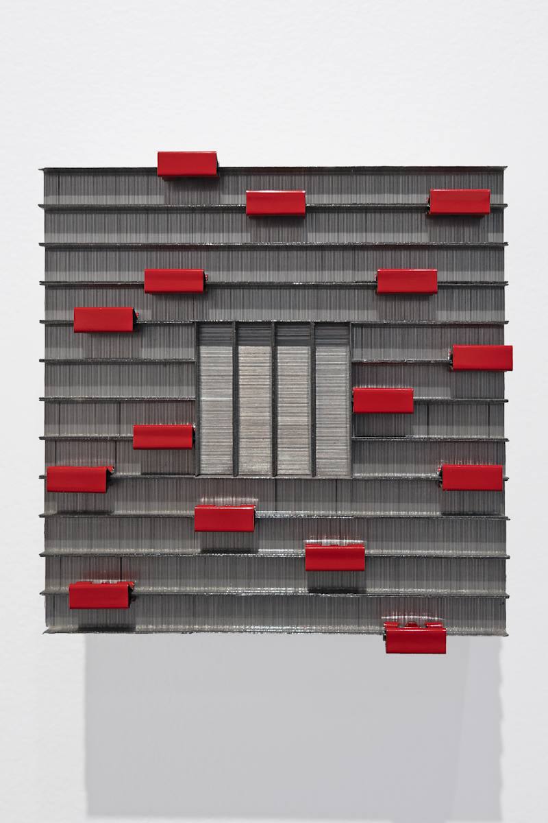 Staples I by Carlo Marcucci  Image: Staples I (revamped 2025 version)
Carlo Marcucci, 2025
Staples and red paper clips on wood, 6" x 6" x 2.5" 