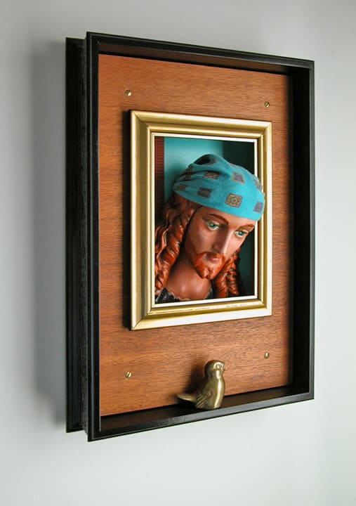 Well Kept by Fletcher Hayes  Image: Hayes' "Well Kept" assemblage features a bearded, bandana-wearing man looking through a window at a small brass bird.