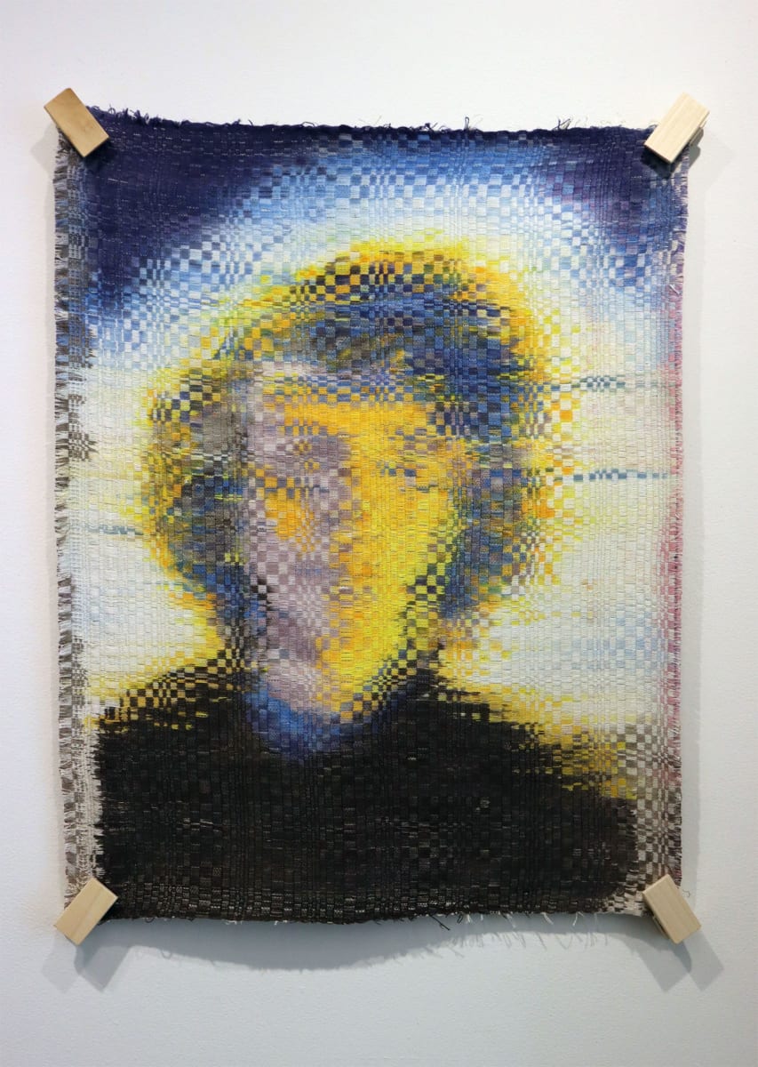 Zoom Break by Melissa English Campbell  Image: Warp painted woven tapestry.  Portrait of a young man dissolving and blurring into geometric patterns
