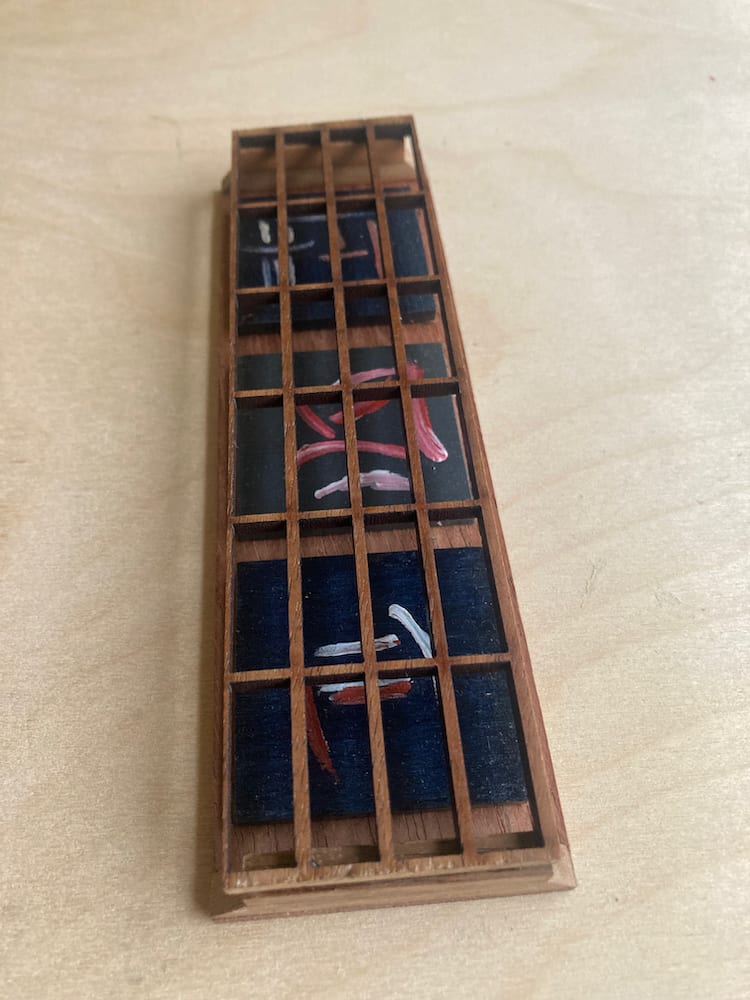 Imagined Post Hànzì/Kanji characters on walnut base. by Mark Johnston  Image: Imagined Post Hànzì/Kanji characters painted on birch tiles mounted on walnut base behind walnut fret-like top layer.