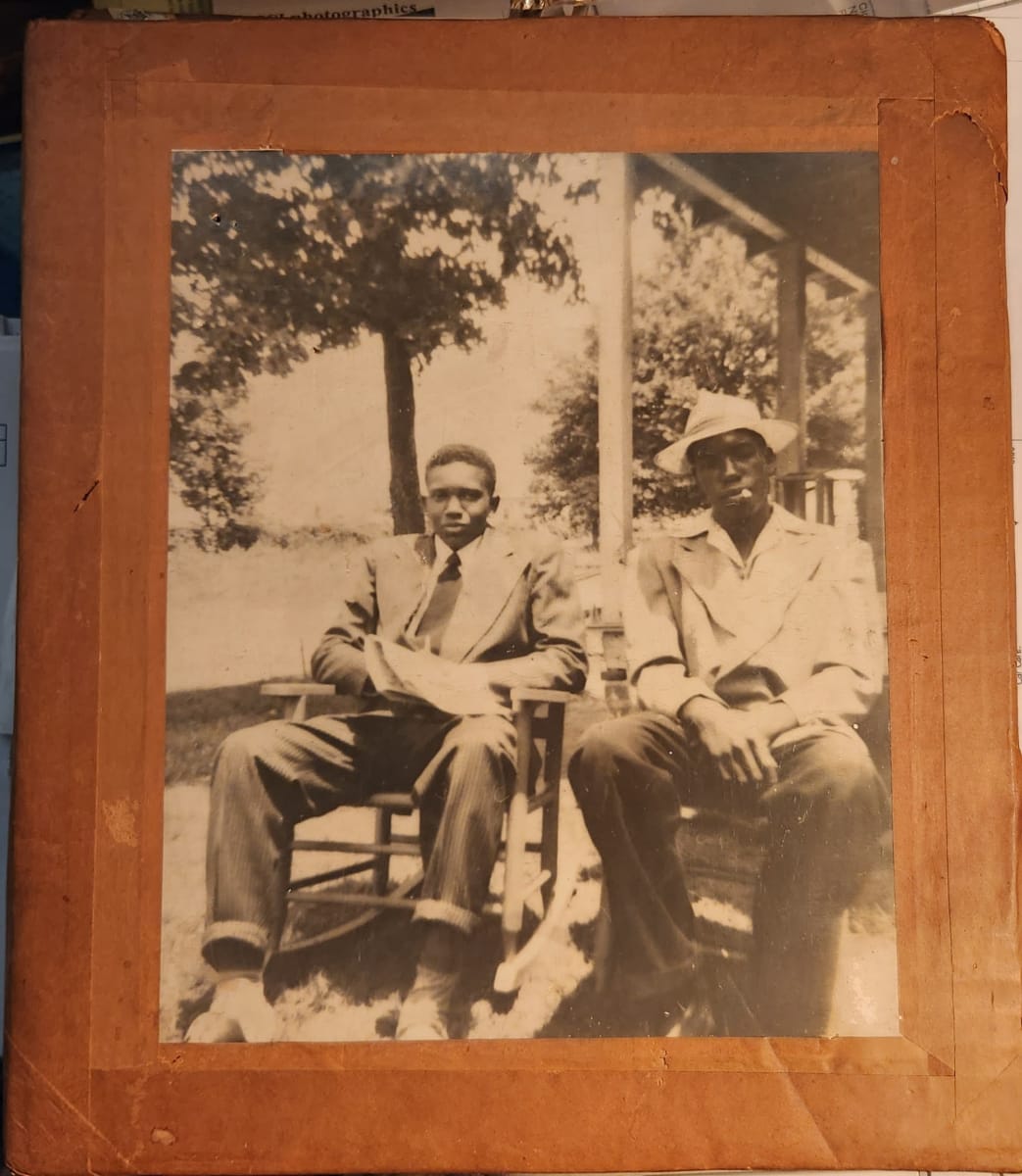 Two Men on Porch, Mound Bayou, MISS by R. Lee Thomas  Image: One of 2 silver gelatin mounted on cardboard frames. Stamp on verso: R. Lee Thomas. Mound Bayou, MISS. "The oldest Negro town in American."