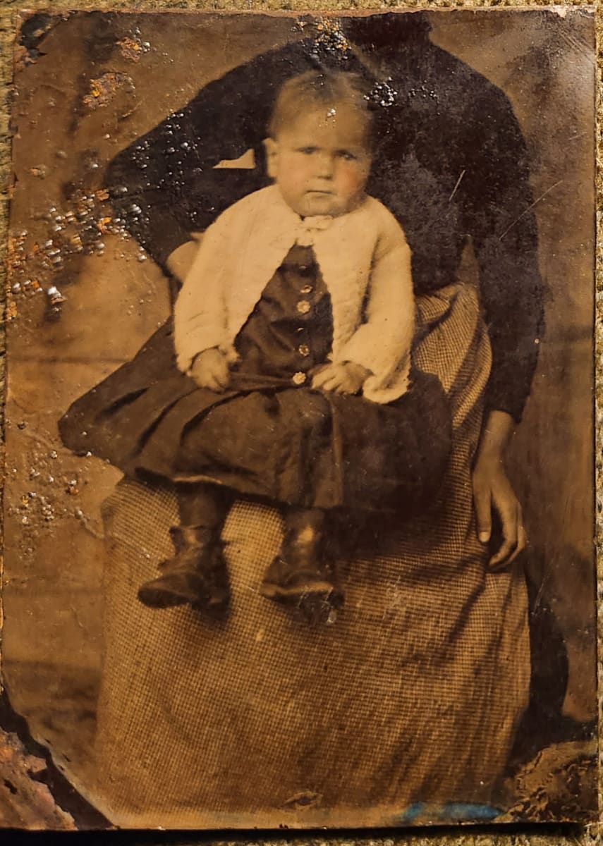 Portrait of child with beheaded nanny!  Image: Another version of the "hidden" mother or guardian...in this case an African-American servant who was only in the picture as a lap for the child.
