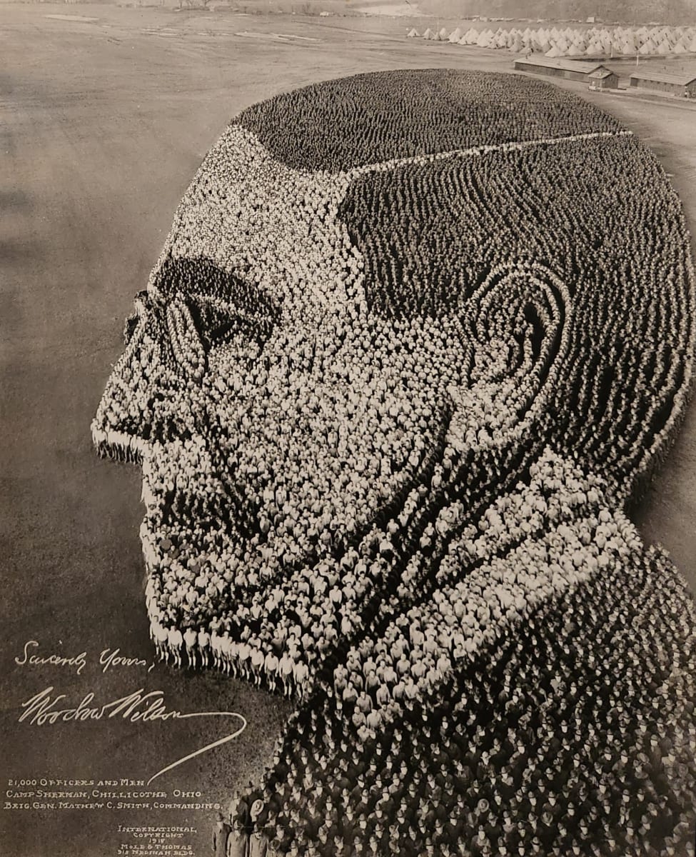 President Wilson: Portrait formed by 21000 men in uniform: Mole and Thomas, 1918  Image: Monumental scale performance art photography. Series of photos each involving thousands of soldiers arranged to create perceptual depth illusion when photographed from a high tower. Used for WWI fund raising.