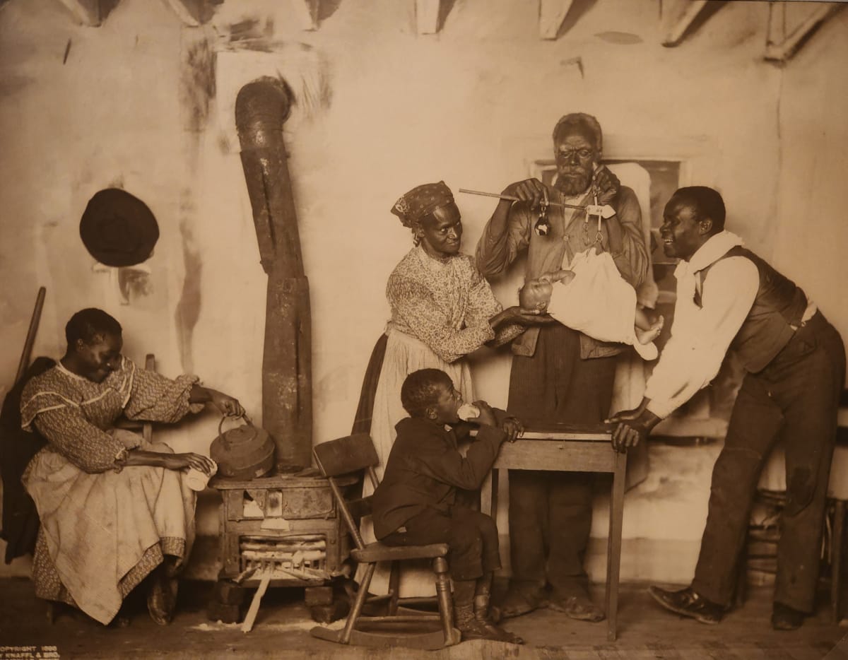Caricature photo of African American birth  Image: Demeaning rascist caricature photo by Knaffle and Bros.  Knoxville, TN. This company produced a variety of large "genre" scenes that were quite popular for display in homes and public settings. This one is titled "Another New Coon in Town."