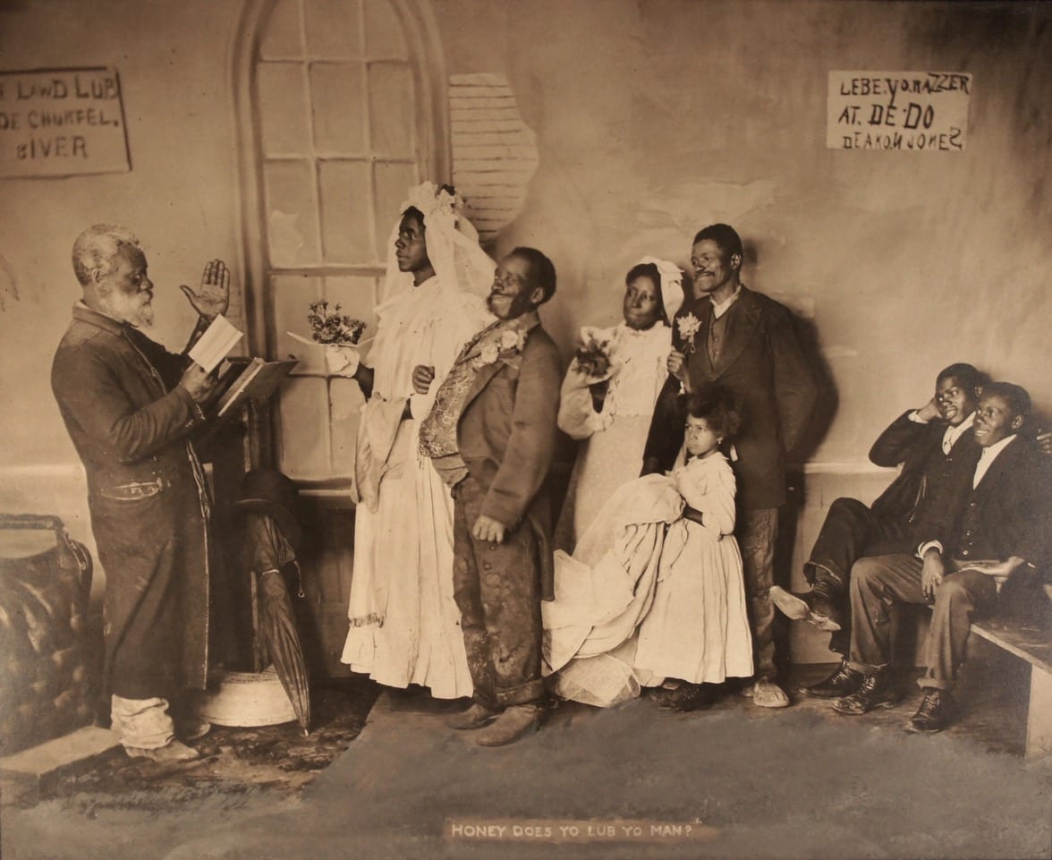 Rascist caracature of wedding ceremony  Image: Demeaning caricature photo by Knaffle and Bros.  Knoxville, TN. This company produced a variety of large "genre" scenes that were quite popular for display in homes and public settings. Note the title and signs on the wall.