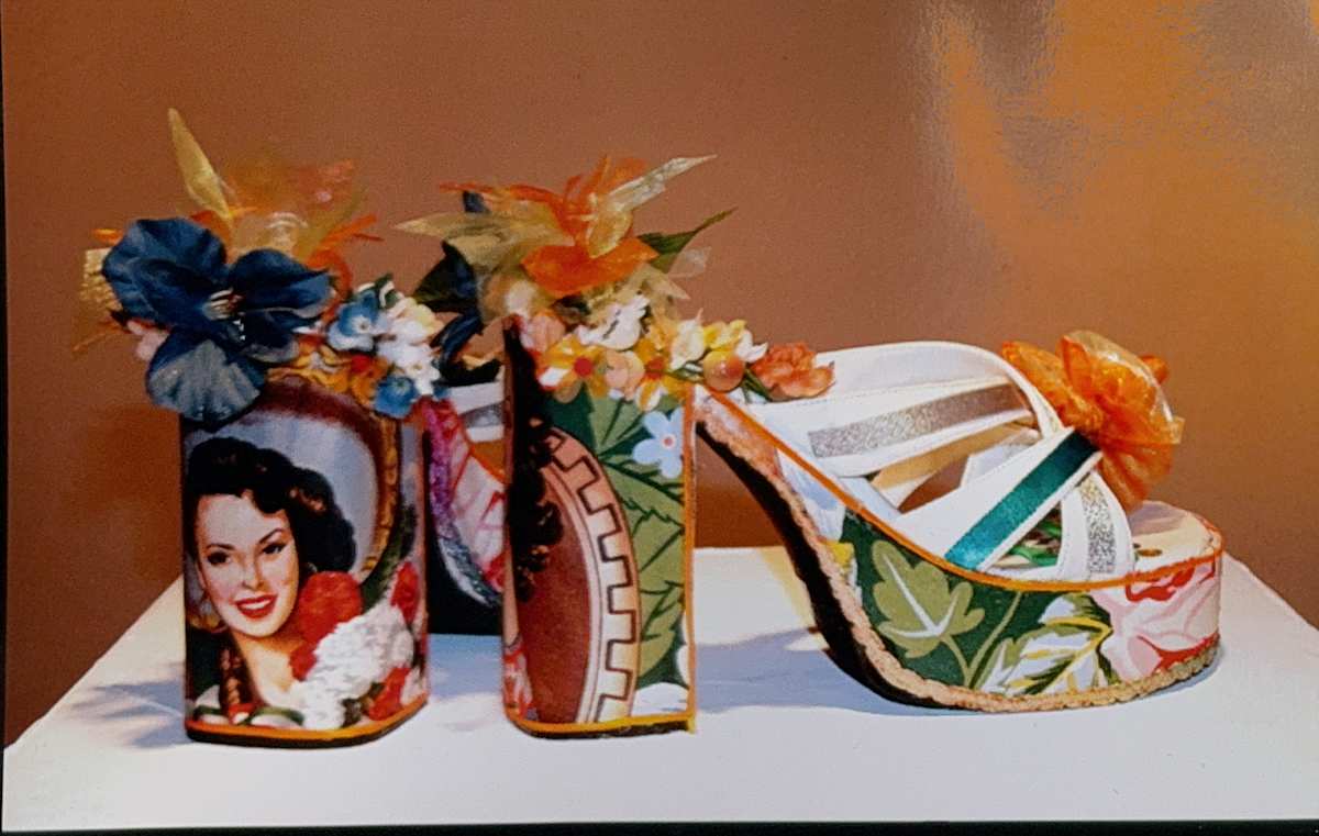 Chanclas by Martha Rodriguez   Image: One of Martha's favorites was her series of "Chanclas" that recalled her disco days of the 70s. These up-cycled sandals were painted  and often embellished with flowers and ribbons. This pair was from the 2007 Solo Mujeres show at The Mission Cultural Center for Latino Arts in San Francisco.  