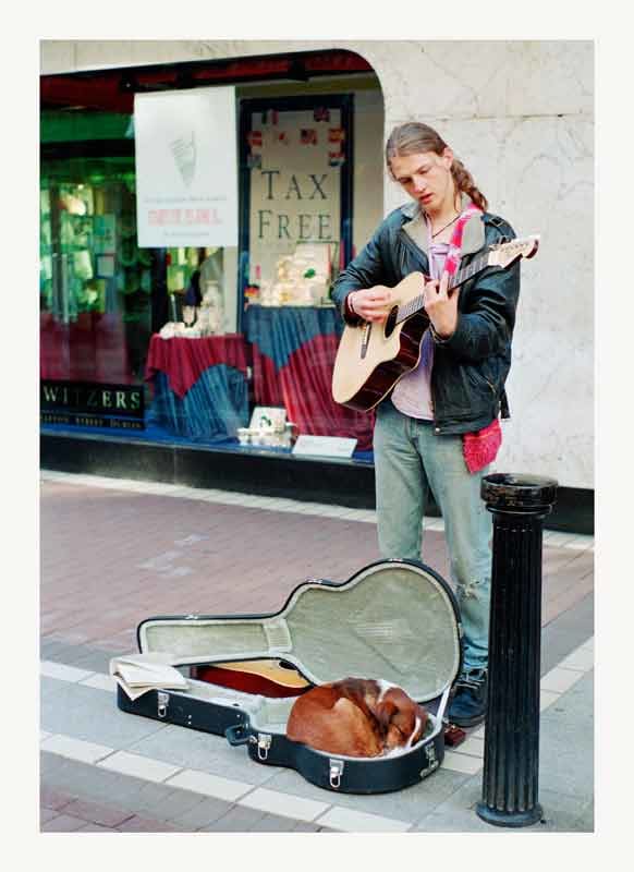 The Critic Sleeps - Grafton Street, Dublin by Laura-Leigh Palmer  Image: Grafton Street guitarist plays while his faithful companion sleeps.