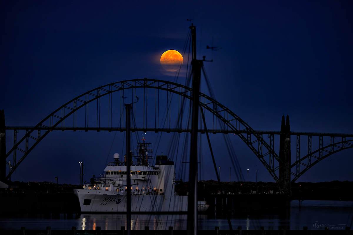 "The Mist" Limited Edition Hand-Crafted Metal, White Gloss, 12" x 18" by Jeremy Likness  Image: The Sturgeon moon sets over a research vessel docked in front of Yaquina Bay Bridge.