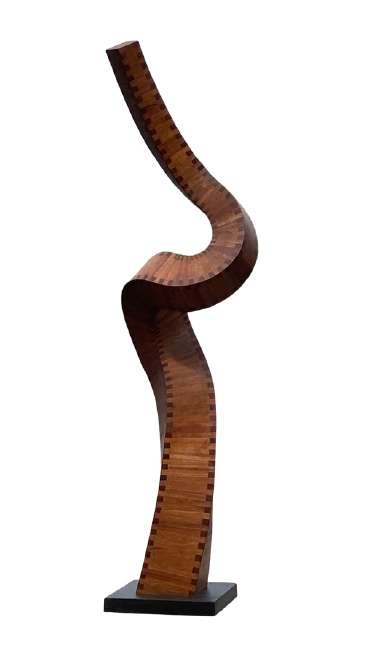 Totem by Jim Perry  Image: Jim Perry began his career as a sculptor in the early 1970's in New York City, and in 1975 was included in the Whitney Biennial. He received his BA in Sculpture from Bard College where he studied with sculptor Jake Grossberg and painters Murray Reich and Jim Sullivan. he works with mahogany using small angular cuts of wood that when layered, create large, dynamic, abstract sculptures; totems, spiraled and flowing pieces. Jim Perry's work has been exhibited extensively over the past 45+ years and is held in many private and corporate collections. "I am fascinated by forms that are both mathematical, like parabolas or spirals, and that also appear in nature, like waves or flight trajectories. In my sculpture, I take the basic principles inherent in these forms and interpret and play with them, allowing each piece to evolve in an intuitive way."