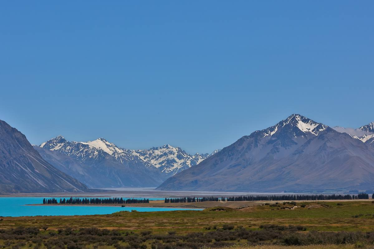 Tranquil lake beneath snowy peaks by EB Photography 