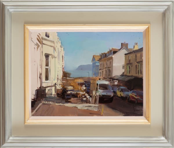 Looking down  sun bleached street to The Little Orme, Llandudno 