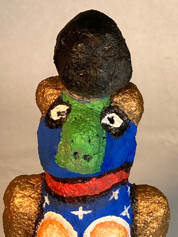 Blue face with green nose and black hat by Jennifer Taylor