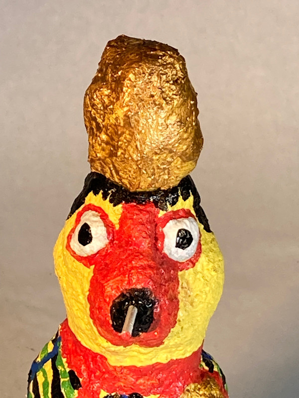 Yellow face smoking with black hair and gold hat by Jennifer Taylor