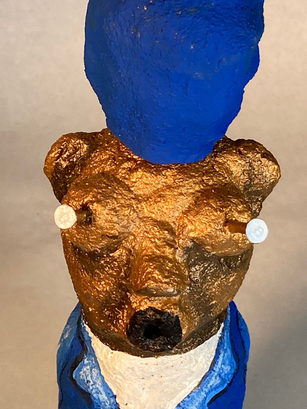 Gold face with nails and blue hat by Jennifer Taylor