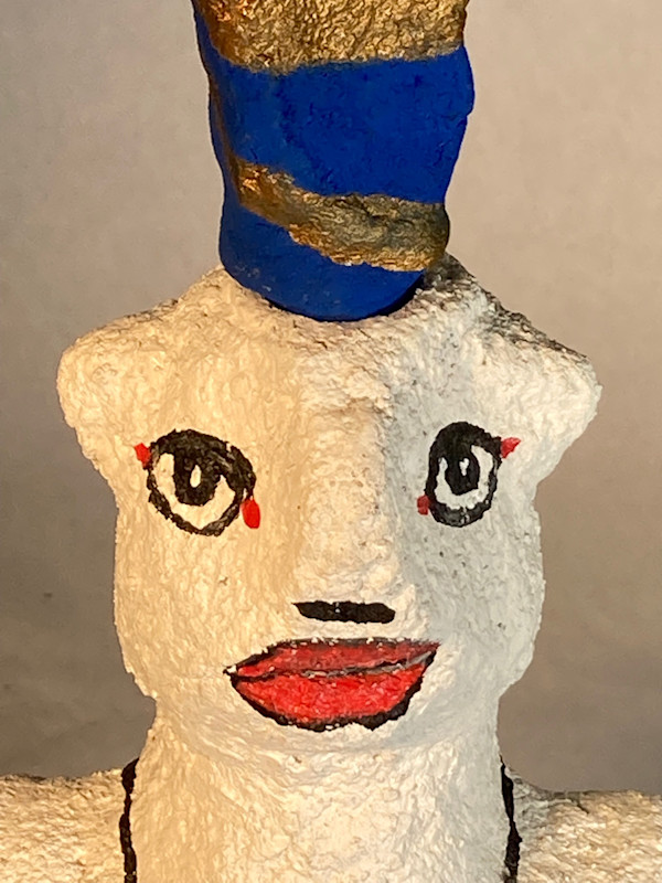 White face with blue and gold hat by Jennifer Taylor