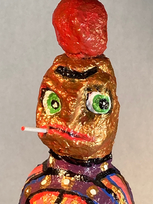 Gold face red hat smoking by Jennifer Taylor