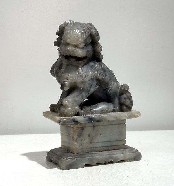 Gray dragon on pedestal