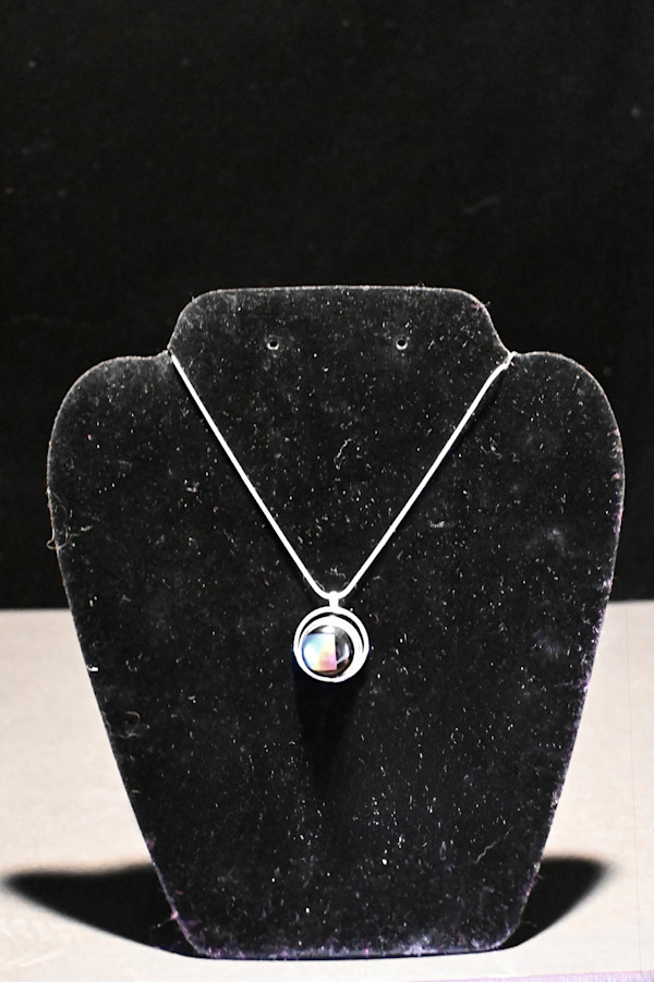 Fused dichroic glass  arc within a circle pendant by Susan Mason