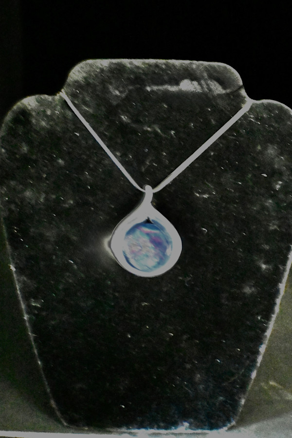 Fused glass dichroic pendant in a tear drop silver setting by Susan Mason