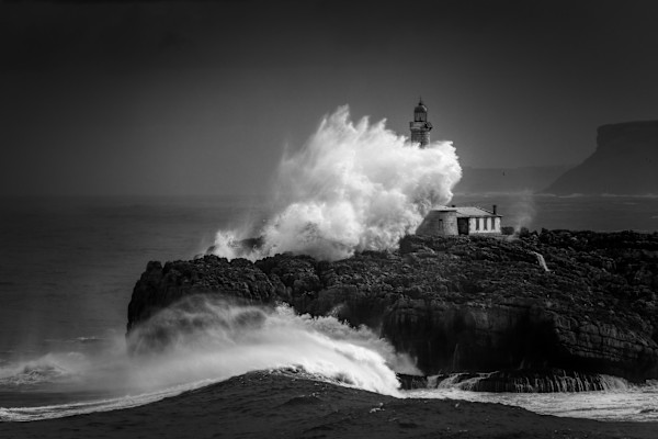 Mouro Island Lighthouse - Wave Splash by Juan Matorras