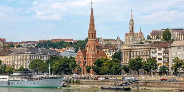View of the Danube river in Budapest, Hungary, featuring two prominent churches. by David Whited