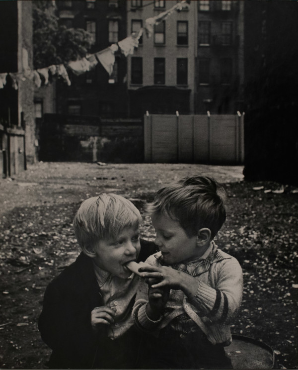 Willie Feeding Banana to a Little Boy by Ken Heyman
