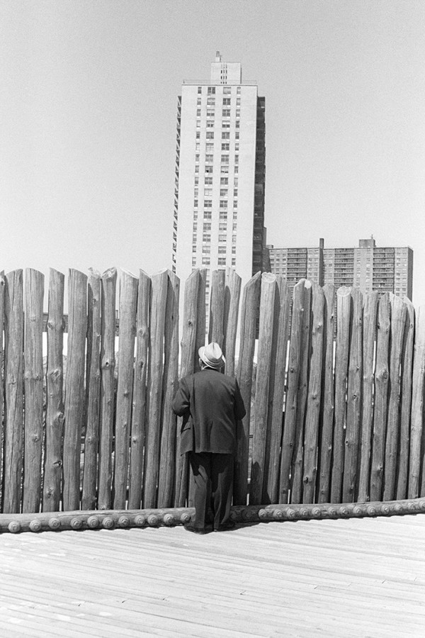 Untitled, (Man Peek Thru Tall Fence) by Karl Baden