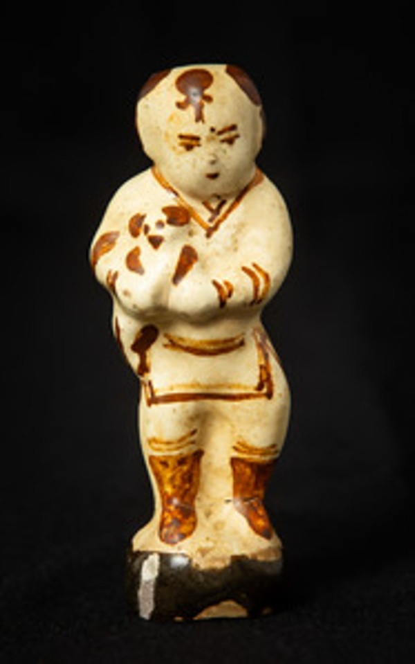 Untitled (Chinese Porcelain Figurine of a Boy Holding a Dog) by Artist Unknown
