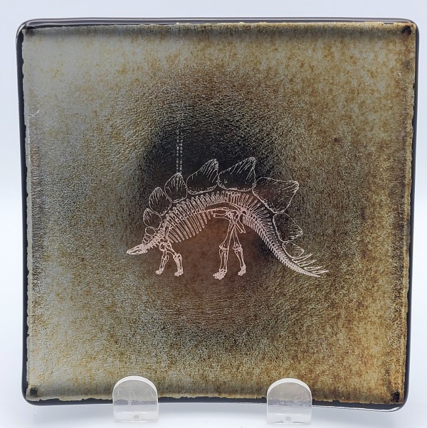 Plate with Silver Stegasaurus Skeleton on Black Irid by Kathy Kollenburn