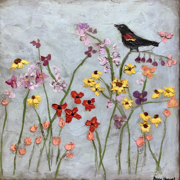 Red winged blackbird in flower field by Anne Hempel