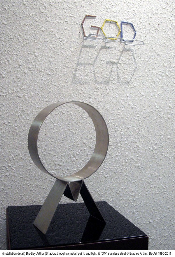 OM-on pedestal  - GOD/ego  on wall by Bradley Arthur