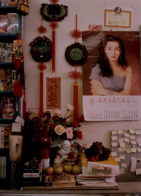 Rochester Asian Market: altar behind counter, Rochester, New York by Marion Faller