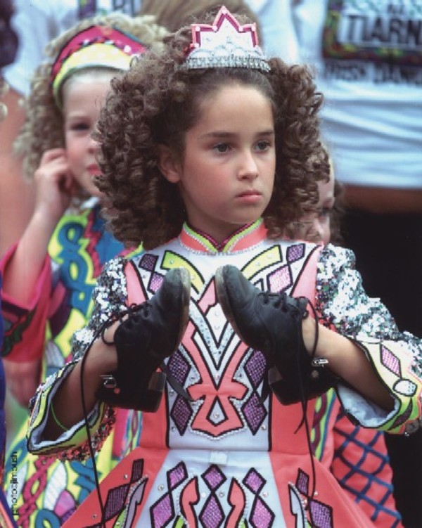 Girl wearing hard shoes on hands by Jim Bush