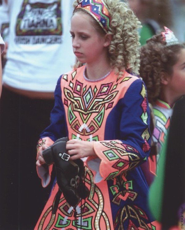 Girl holding hard shoes in left hand by Jim Bush