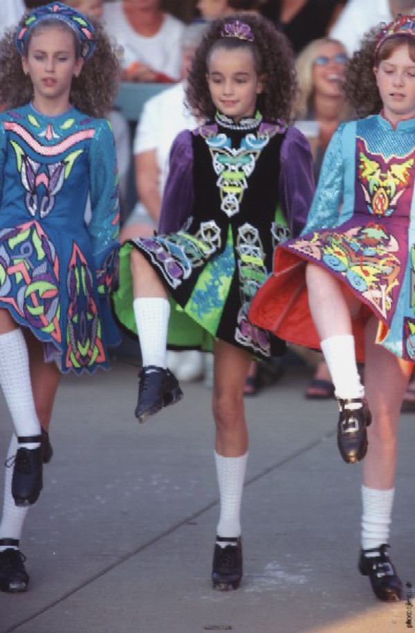 Three dancers with right knees raised by Jim Bush